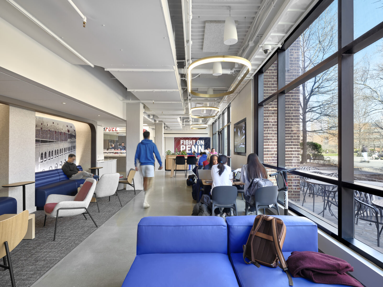 The main dining and collecting area is bookended by a custom Fight On Penn mural